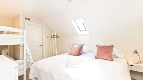 a bedroom with a white bed with two pillows at The Telephone Exchange at Parsley Hay in Buxton