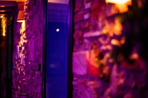 a wall with purple lights in a room at RhelizeOne & Spa جميل in Palermo