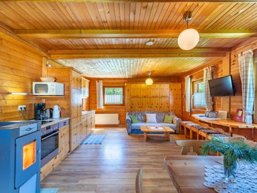 a kitchen and living room in a log cabin at Holiday Home Weissmann by Interhome in Mayerling