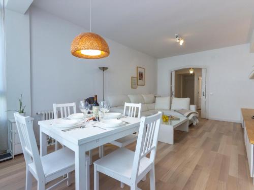 a white dining room with a white table and chairs at Apartment Chamartin-Ciudad Ramos Carrion by Interhome in Madrid
