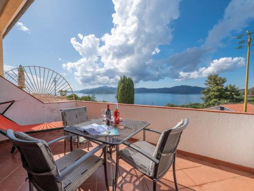 a table and chairs on a balcony with a view of the water at Apartment Turistica-2 by Interhome in Capoliveri