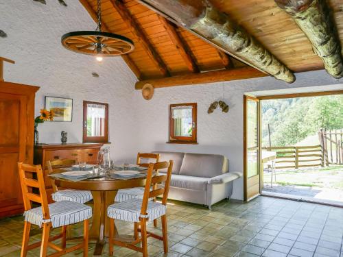 a living room with a table and chairs and a couch at Holiday Home Rustico Girasole by Interhome in Leontica