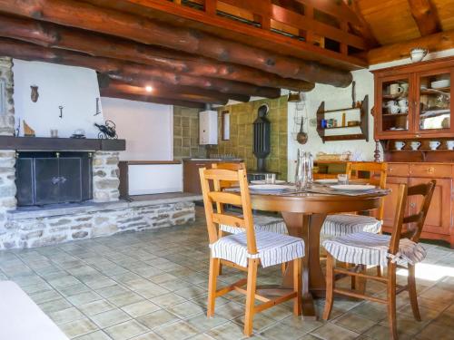 a kitchen with a table and chairs and a fireplace at Holiday Home Rustico Girasole by Interhome in Leontica