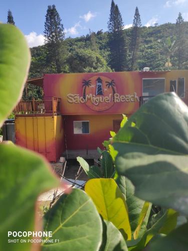a building with a sign on the side of it at Pousada São Miguel Beach Beira Mar in Penha