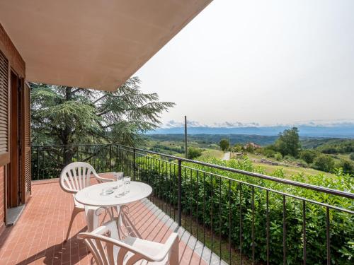 a patio with a table and chairs on a balcony at Holiday Home Pinetina by Interhome in Bossolasco