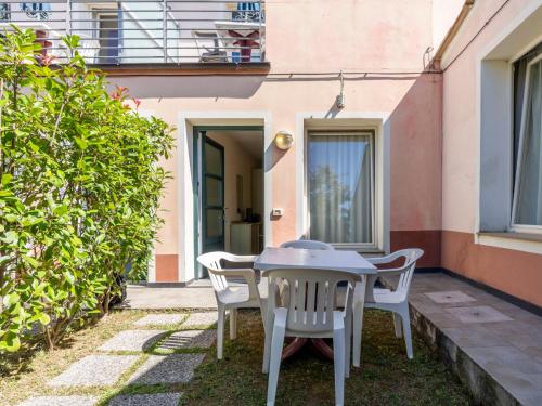 a patio with a table and chairs in front of a building at Studio Borgoverde-11 by Interhome in Imperia