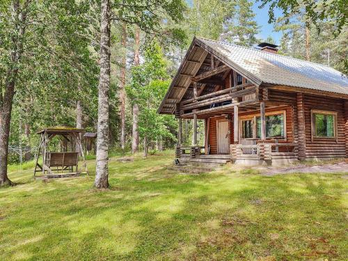 a log cabin in the woods with a gazebo at Holiday Home Koivula by Interhome in Soini