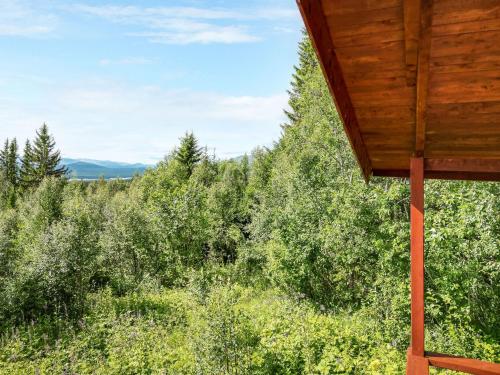 a view from the porch of a cabin in a forest at Chalet Högvallen Elden - JAM025 by Interhome in Undersåker