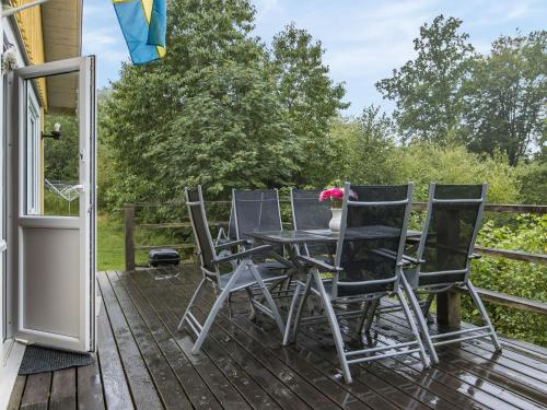 a patio with a table and chairs on a deck at Holiday Home Gaslunda - B in Olofström