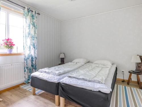 a bedroom with a bed in a room with a window at Holiday Home Gaslunda by Interhome in Olofström