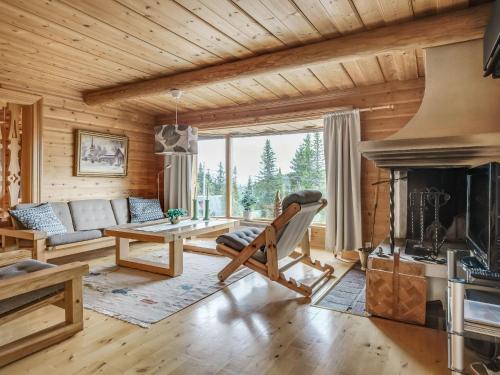 a log cabin living room with a fireplace at Chalet Korpstigen Älgen - DAN075 by Interhome in Sälen