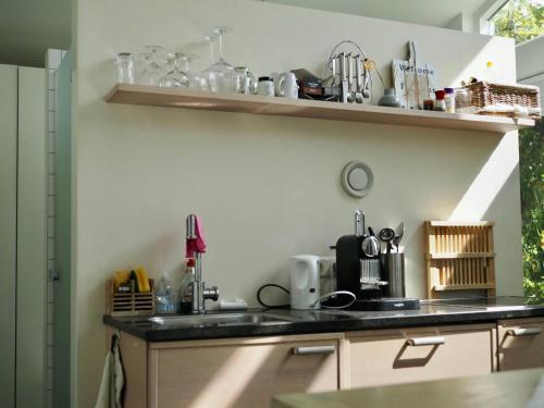 a kitchen with a sink and a counter top at Chalet De Orangerie by Interhome in Zaamslag