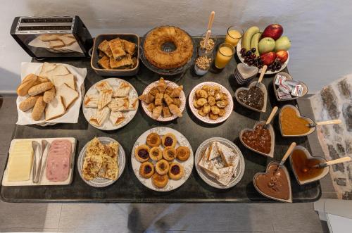 a table topped with lots of different types of food at Mountain's Secret in Mouresi