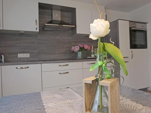 a vase with a flower on a table in a kitchen at Apartment Walzthöni by Interhome in Wenns