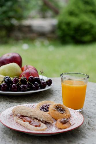 two plates of fruit and a glass of orange juice at Mountain's Secret in Mouresi