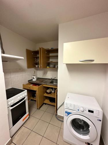 a small kitchen with a washing machine in it at Bydlení v Brumově s.r.o. in Brumow