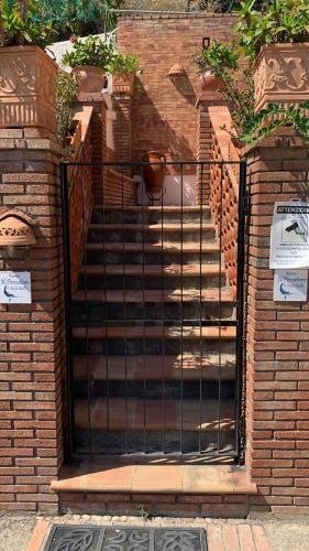 a set of stairs with a black gate at Isola Bella - Rooms il Pescatore in Taormina