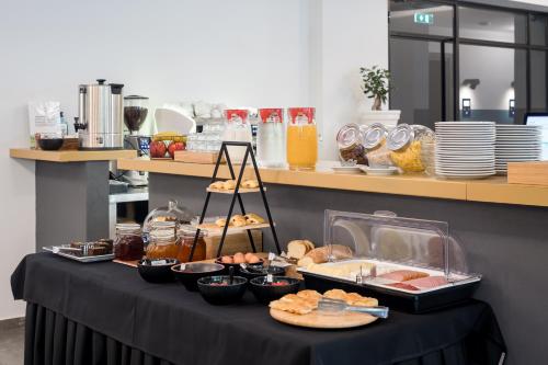 a table with food on it in a kitchen at Centro Hotel Ioannina in Ioannina