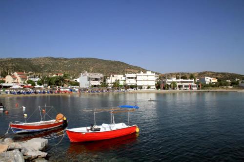 two boats are docked in a body of water at Hotel Stella in Volos