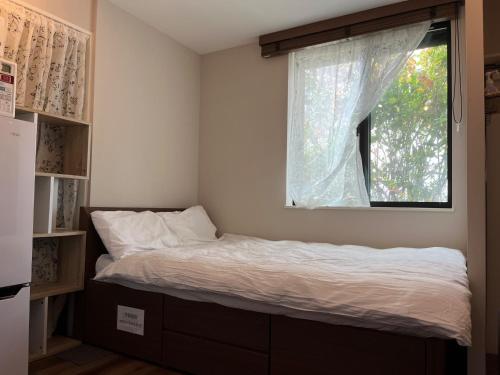 een bed in een kamer met een raam bij Meguro-ku - House - Vacation STAY 8878 in Tokyo