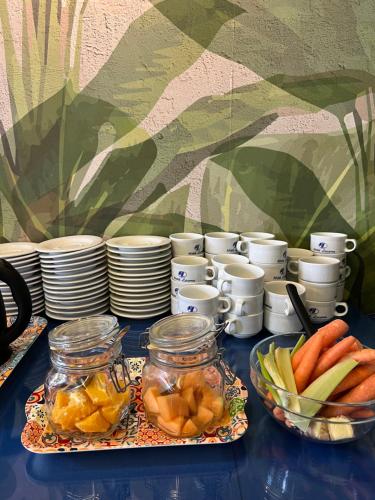 a table with plates and bowls of fruits and vegetables at Hotel Lucerna in Castiglione della Pescaia