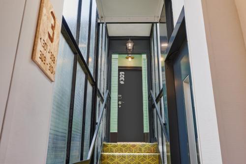 a hallway with stairs in a building with a door at Greet Boulogne Billancourt Paris in Boulogne-Billancourt