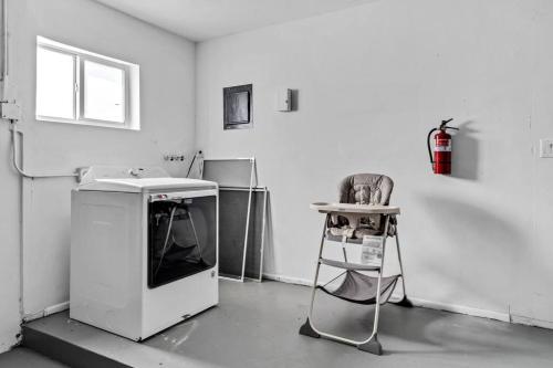 a kitchen with a sink and a chair in a room at Relaxing Getaway 4 Bedroom, Pool and 18 minutes to the Beach in Miramar