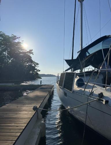 a boat is docked next to a dock at Akwaba Lodge in The Gap