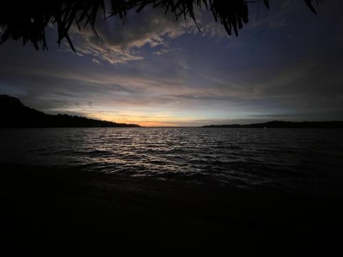 a sunset over a large body of water at Akwaba Lodge in The Gap