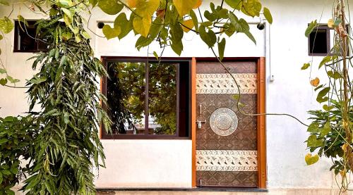 a front door of a house with a window at Hotel Kota kunj Heritage in Pushkar