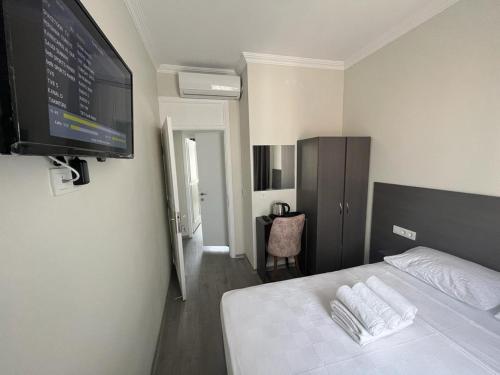 a bedroom with a bed and a flat screen tv at Maritsa Comfort Plus in Edirne