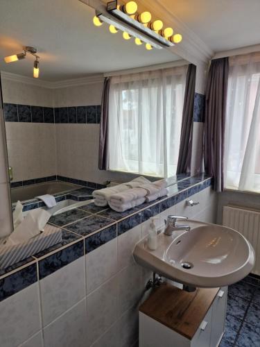 a bathroom with a sink and a mirror at H5 Hotel Bremen in Bremen