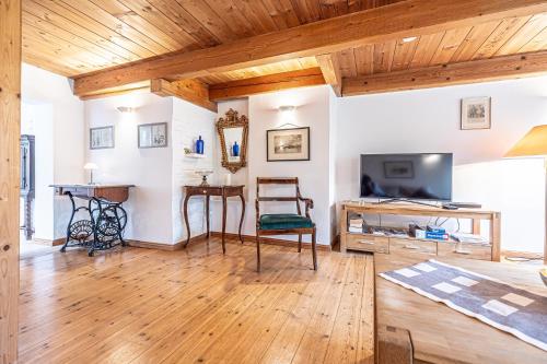 a living room with wooden ceilings and a television at fewo1846 - Altes Steuermannhaus - uriges Reihenhaus mit 2 Schlafzimmern in der Altstadt in Flensburg