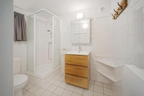 a white bathroom with a sink and a toilet at Domaine Long Pre in Stavelot