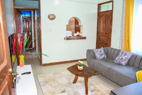 a living room with a couch and a table at Urban Oasis in Kakamega