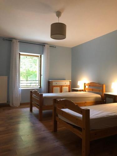 une chambre avec deux lits et une fenêtre dans l'établissement Gîte des Alondrons, à Lissey