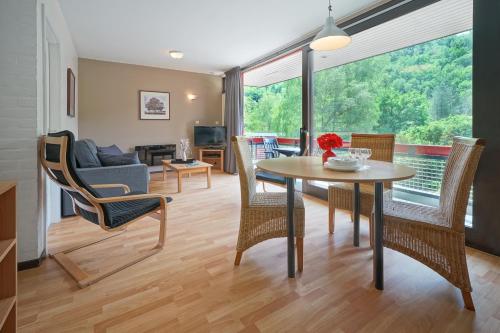 a living room with a table and chairs at Domaine Long Pre in Stavelot