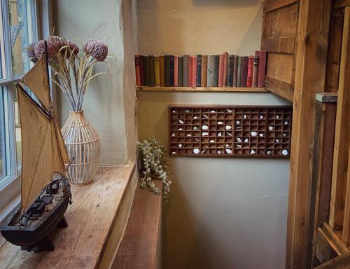 a room with a shelf of wine bottles at The Barley Mill in Bude