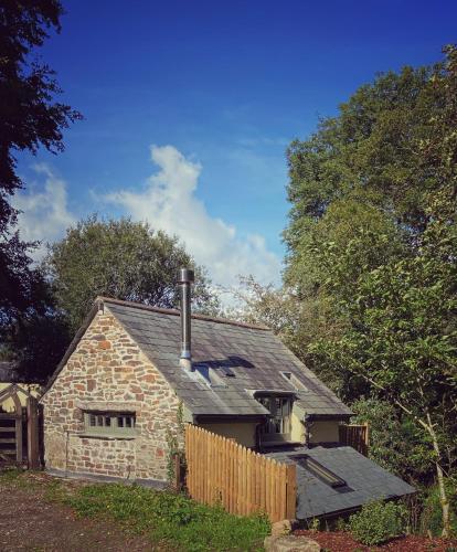 a brick house with a chimney on top of it at The Barley Mill in Bude