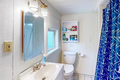 a bathroom with a white toilet and a sink at Captain Rich in Dennis Port