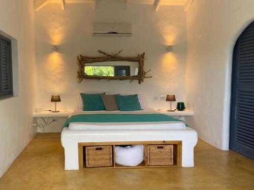 a bedroom with a bed with two tables and a mirror at Spectacular Cozy Sea View Staffed Villa in Las Terrenas