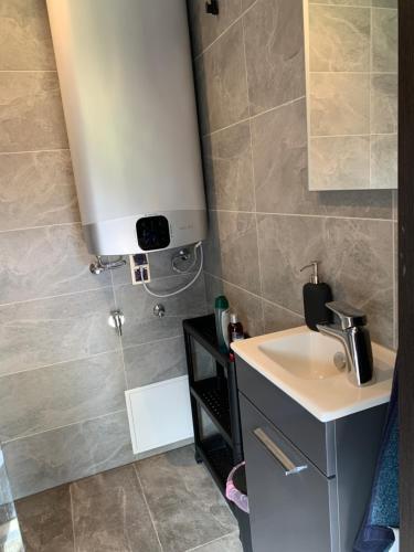 a small bathroom with a sink and a counter at Privaatne saunaga puhkemaja metsa sees 
