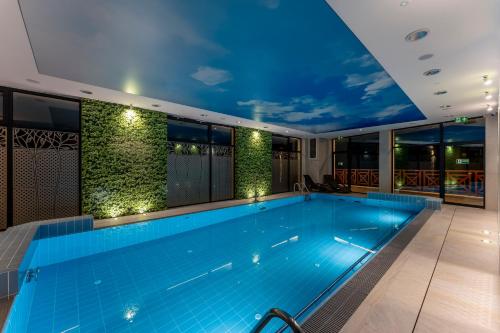 a swimming pool on the roof of a building at Aura Medical SPA Nałęczów in Nałęczów