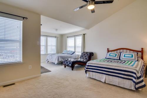 a bedroom with a bed and a chair at Luxury Ocean City Retreat with Beautiful Bay Views in Ocean City