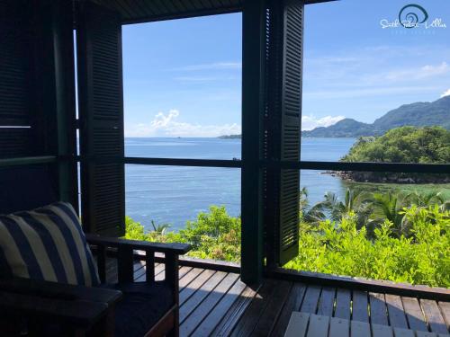 a room with a window looking out at the ocean at South Point Villas Cerf Island in Cerf Island