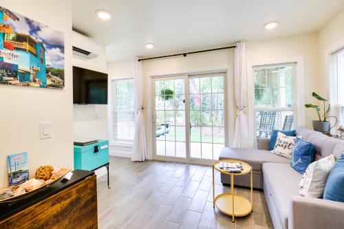 a living room with a couch and a table at Cozy Cottage Minutes to Downtown Southport! in Southport