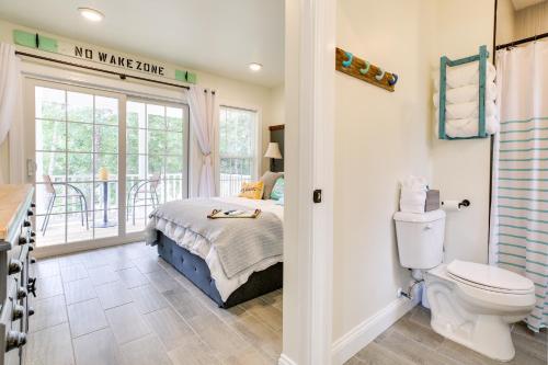 a bathroom with a bed and a toilet in a room at Cozy Cottage Minutes to Downtown Southport! in Southport