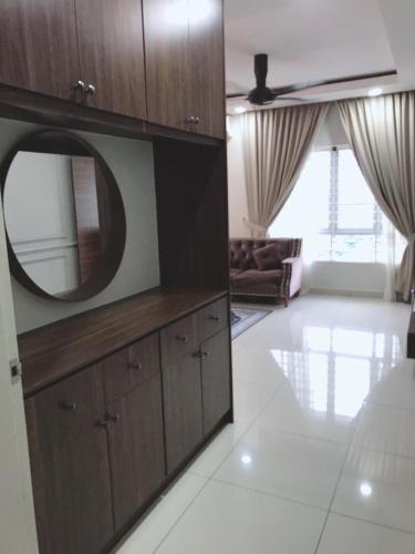 a living room with a large wooden cabinet with a mirror at teratak akilla in Putrajaya