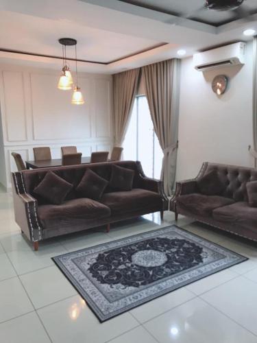 a living room with two leather couches and a rug at teratak akilla in Putrajaya