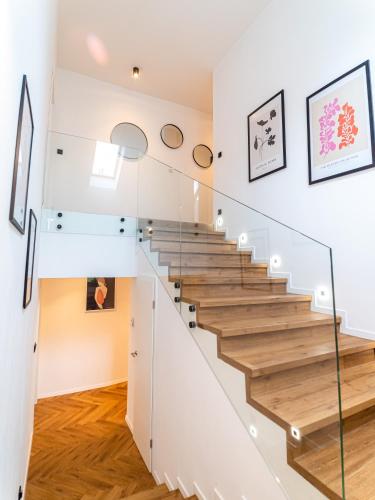 a staircase in a house with glass railing at Villa u zámku Sobotín in Sobotín